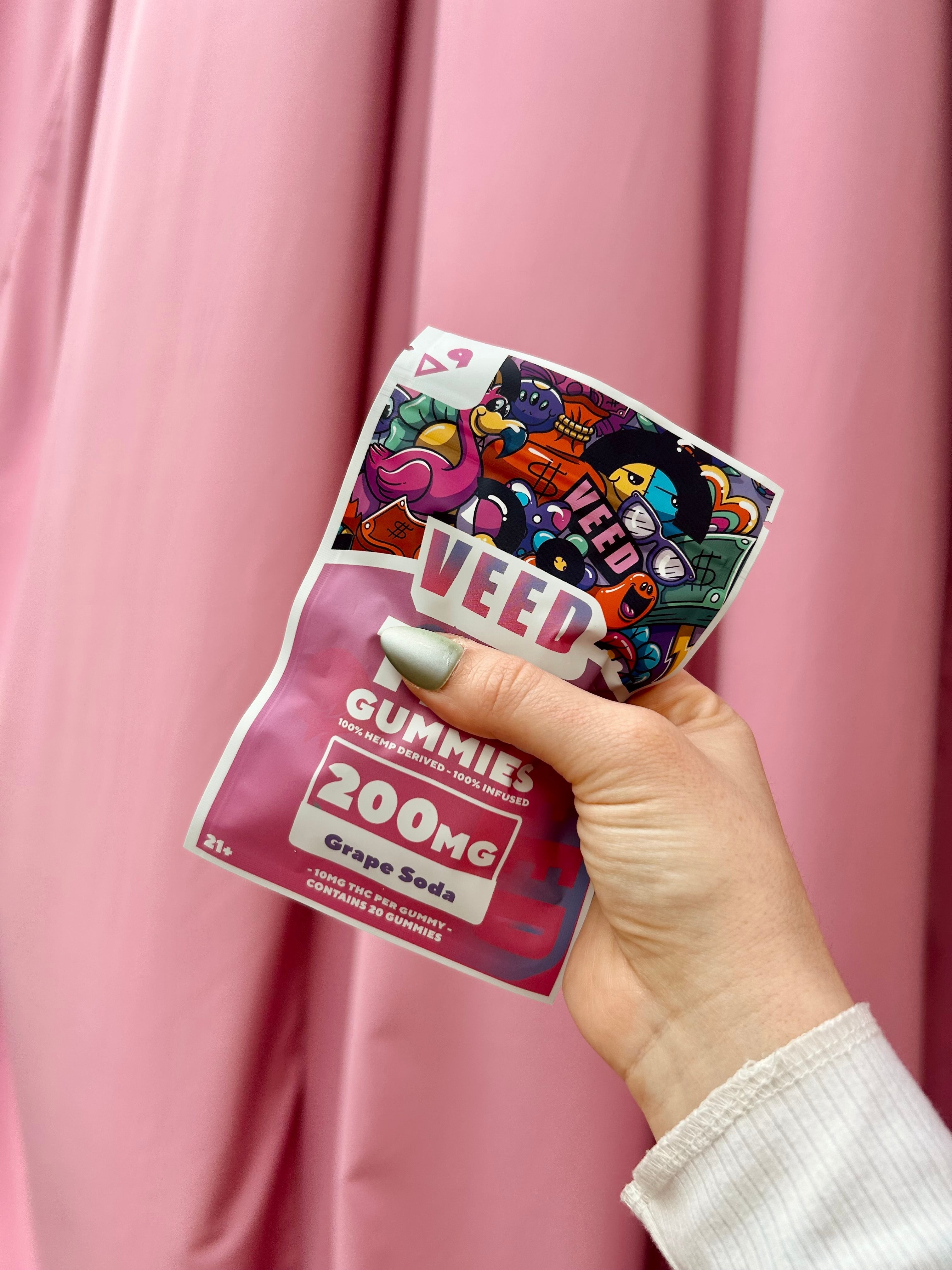 Packaged gummies held up against a pink backdrop, featured in an educational blog about digestive sensitivity and THC Treat products.
