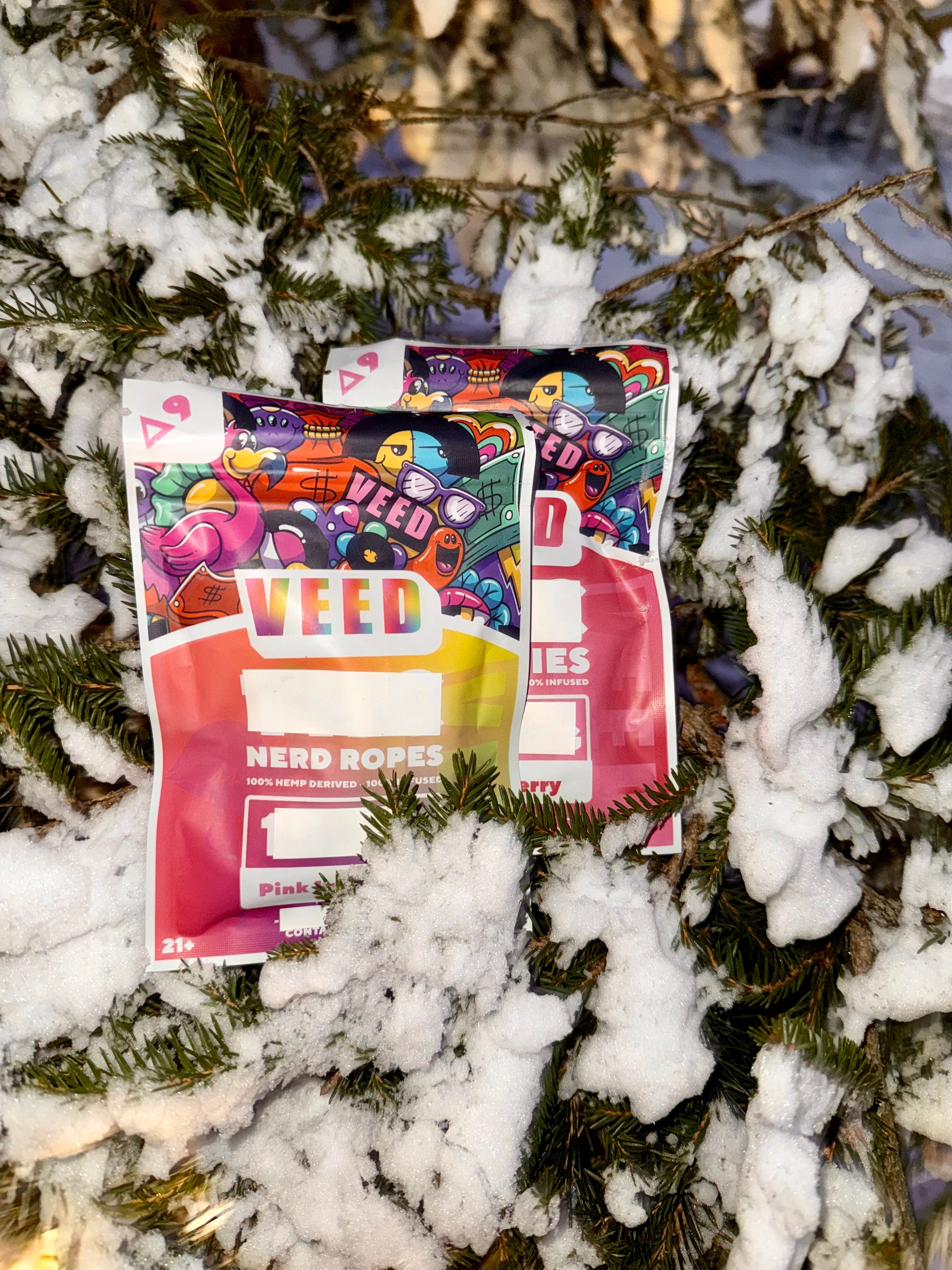 Bottle of VEED THC gummies placed on a granite surface, showcasing cannabis edibles packaging.