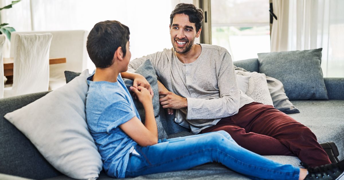 Father talking to son about children THC gummies and safe storage of cannabis edibles.