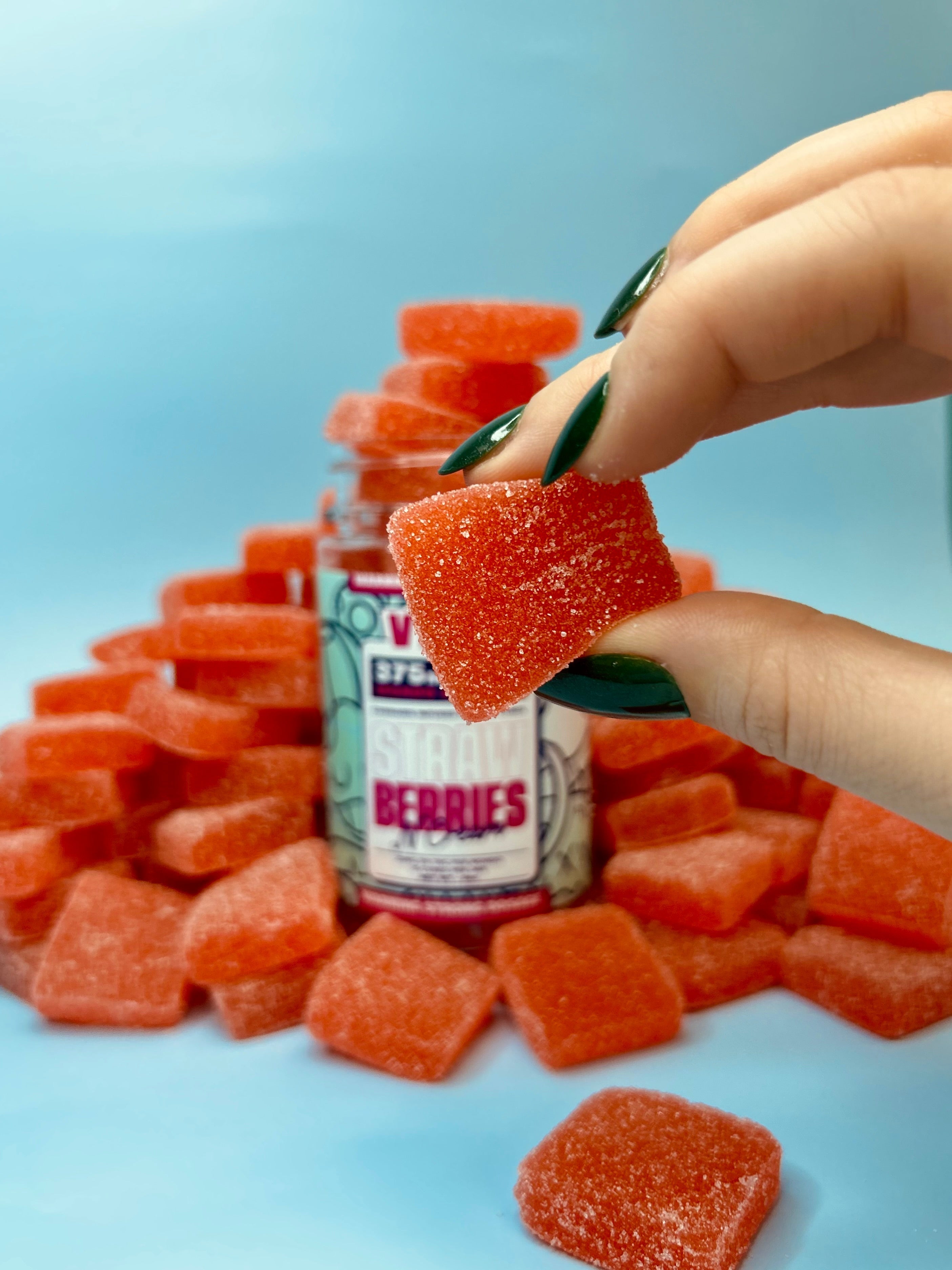 A Guide to THC Edibles (women holding a VEED Gummy)
