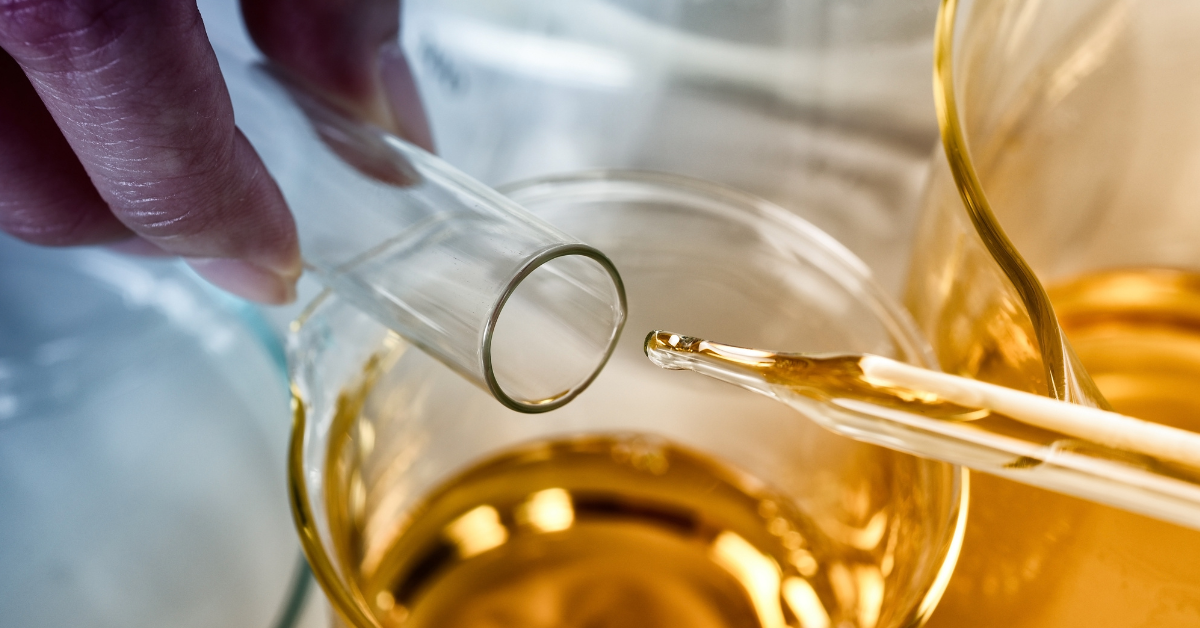 THC vs HHC comparison concept with cannabis oil in laboratory glassware showing cannabinoid extraction and potency differences.