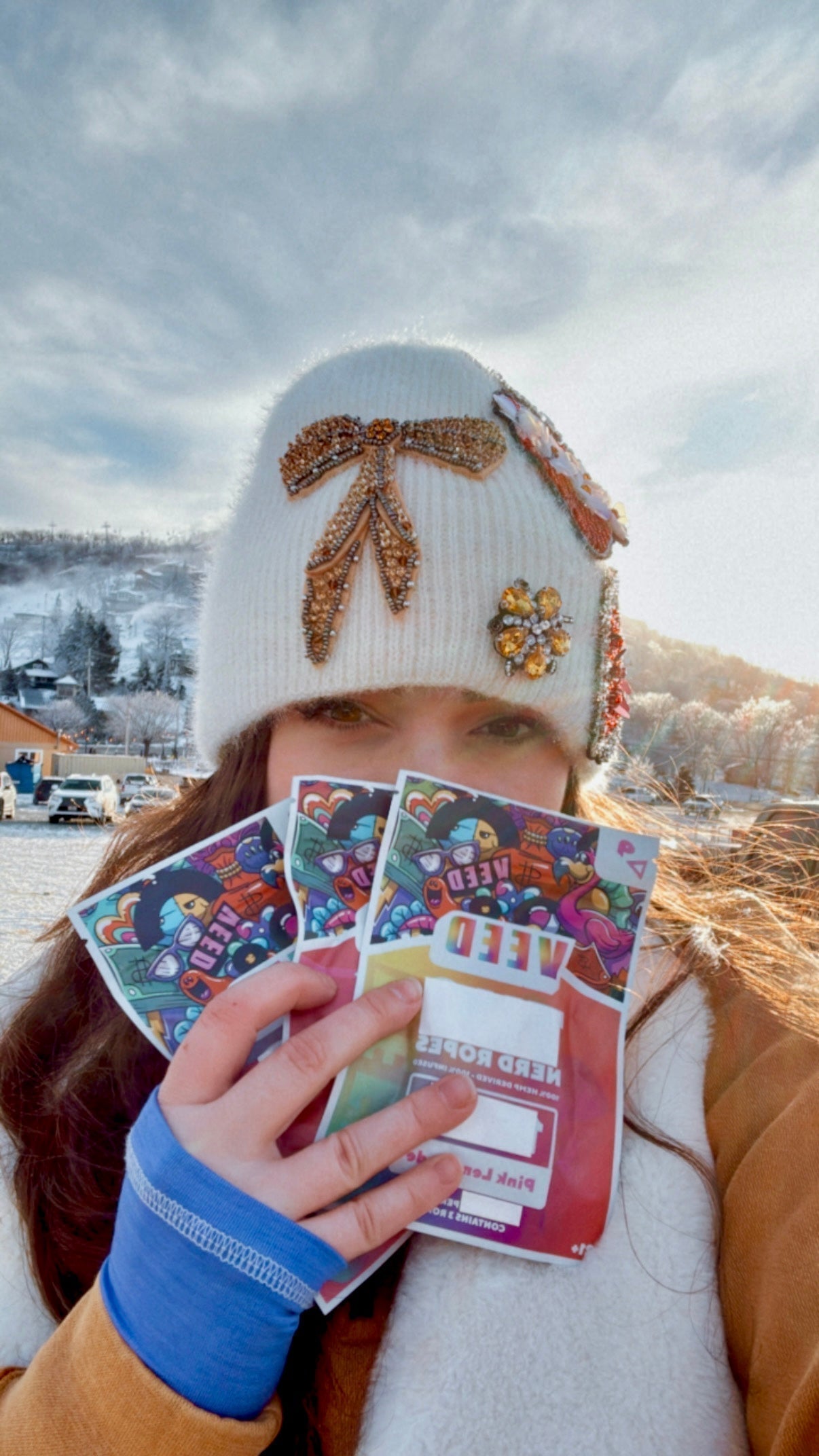 Person holding packs of THC gummies outdoors, showcasing Veed cannabis edibles for freshness and quality.