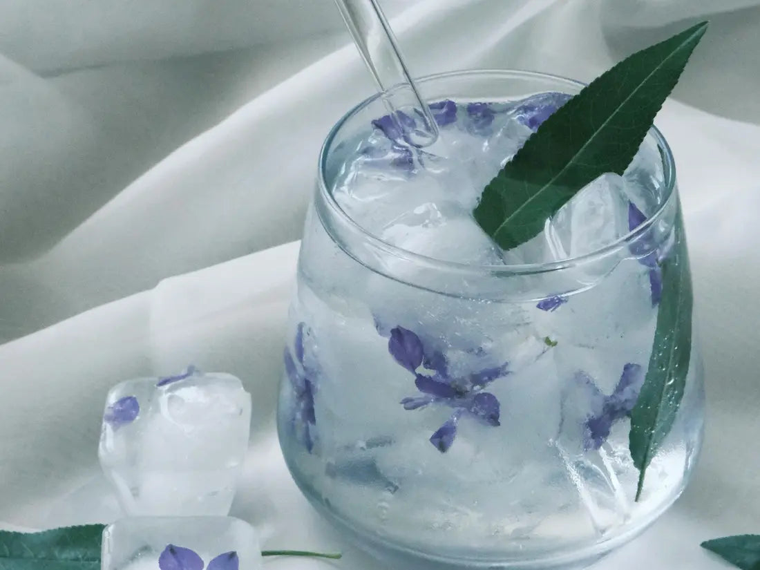 VEED non-alcoholic cannabis drink with floral ice cubes and fresh garnish